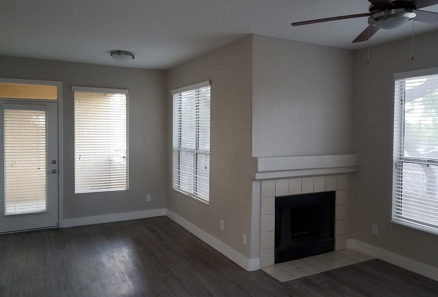 Hardwood floors and fireplace in model home living room at The Retreat Apartments