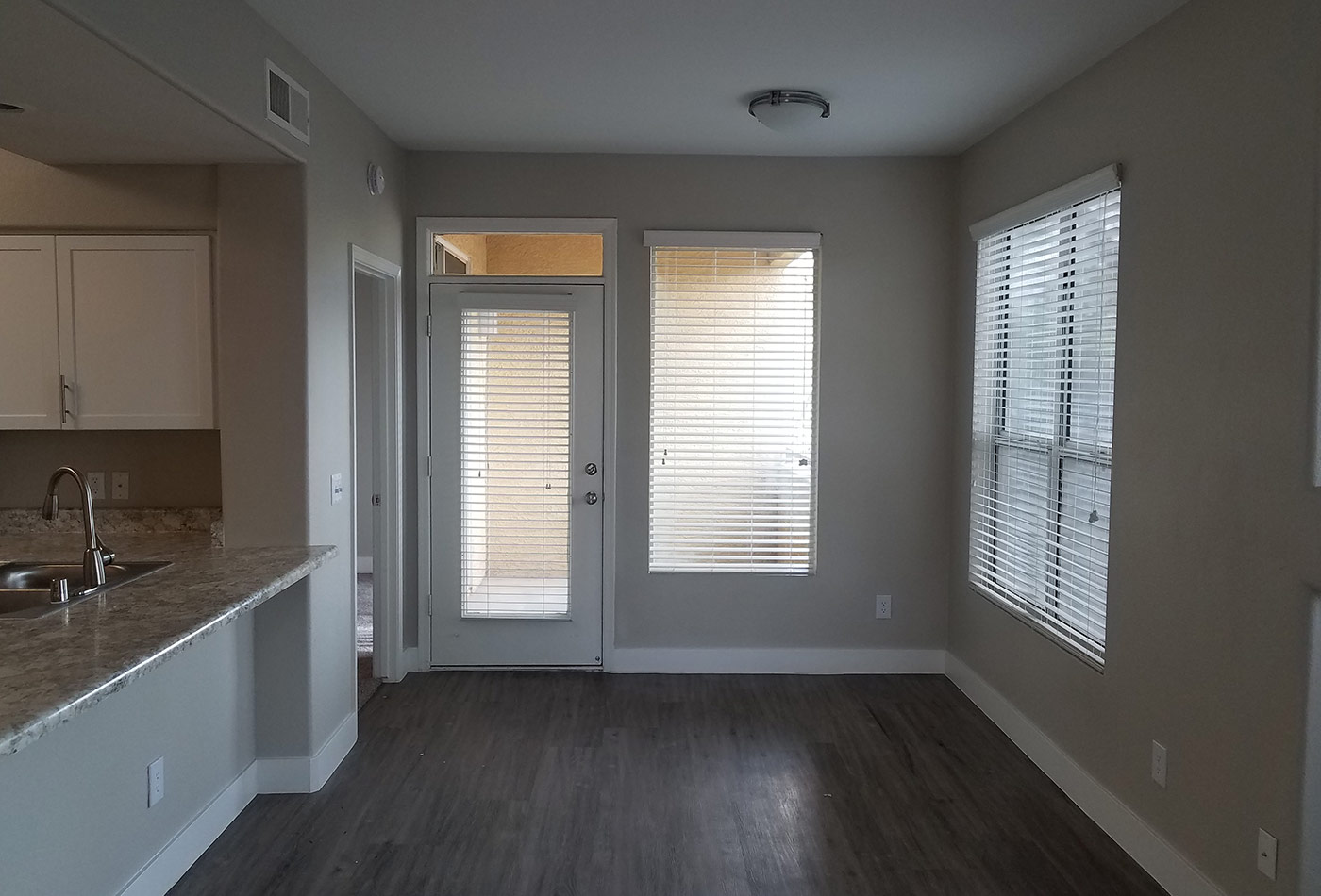 Dining room showcasing hardwood floors in model home at The Retreat Apartments