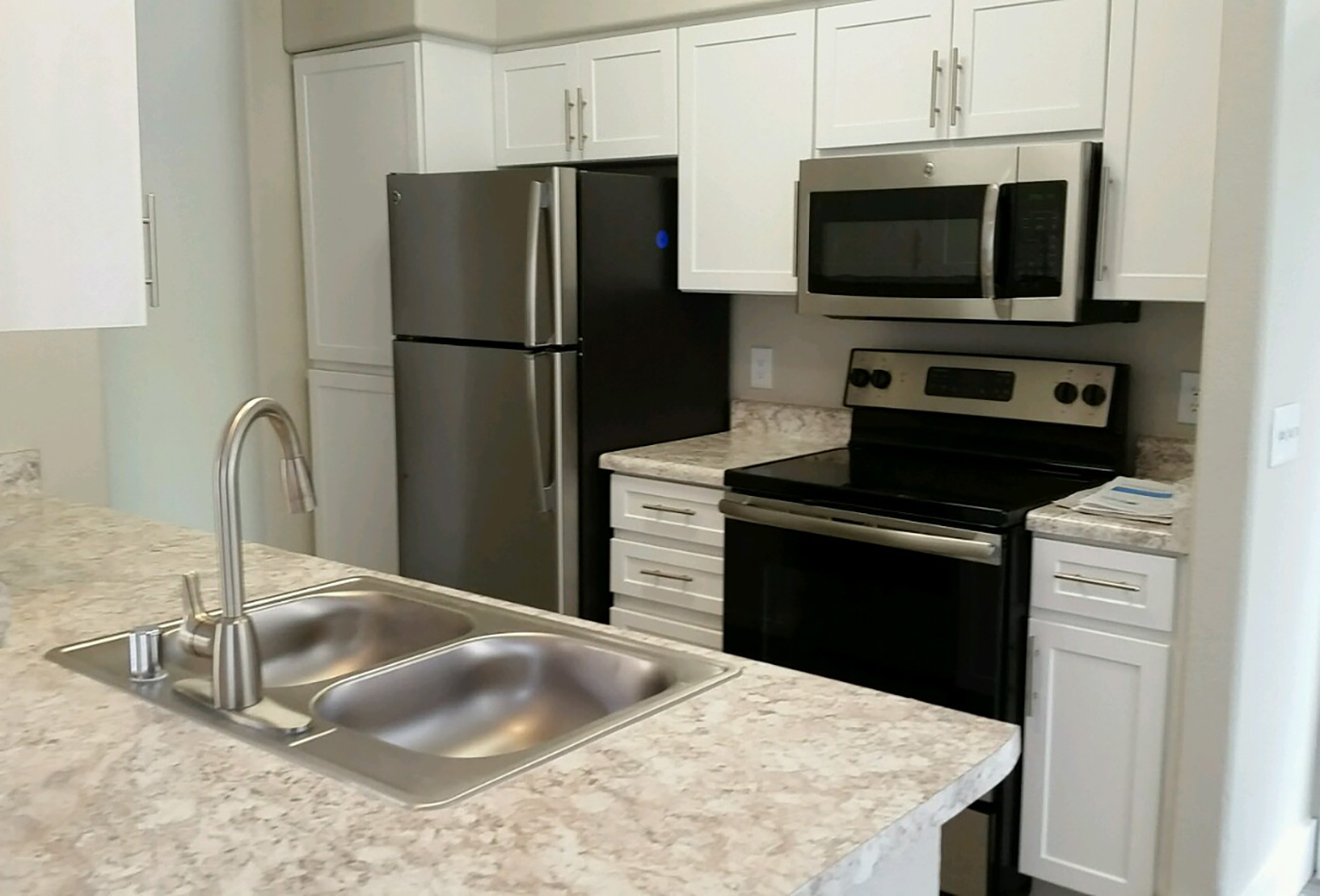 Modern and well-equipped kitchen in model home at The Retreat Apartments