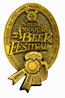 A gold-colored badge featuring the text "National Beer Festival" with a beer mug and ribbon design.