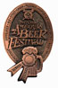 A bronze-colored badge featuring the text "Beer Festival" with a ribbon design at the bottom.