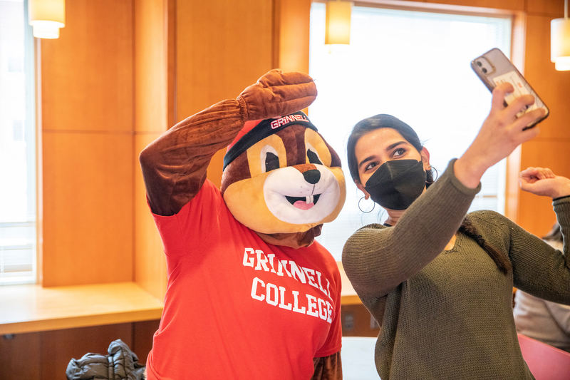 Photo of Scarlet the squirrel with a student