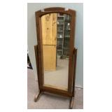 Rustic wooden cheval mirror with a hinged design.