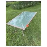 Glass top patio table, four chairs, with cover