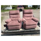 Pair of pink recliner/swivel chairs.