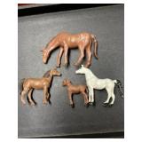 Four plastic horse toy figurines