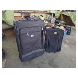 Two Black Wheeled Suitcases with Telescoping Handl