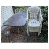glass top patio table and plastic lawn chair