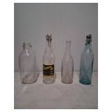 Four Glass Bottles with Embossed and Label Details