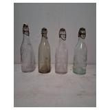 4 Embossed Glass Bottles with Ceramic and Wire Sto