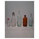 5 Glass Bottles With Varied Designs and Colors