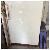 Upright Freezer With Assorted Items on Top