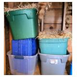 Stacked Plastic Storage Bins With Straw Bedding