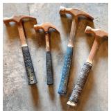 Four Rusted Claw Hammers with Rubber-Grip Handles