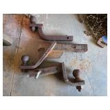 Three Rusted Trailer Hitch Ball Mounts