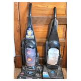 Two Upright Vacuum Cleaners Needing Repairs