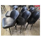 Six black bar stools