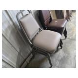 Four grey stacking chairs