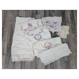 Lace border tablecloth; hand embroidered doilies;