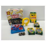 Alex Talking Tubes, Tic-Tac-Toe Game, Crayola Markers and Crayons, Learning Resources Magnet, and Tomica Vehicle