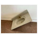 Solid Surface Vanity Countertop with Integrated Sink and Brass Tone Fixtures