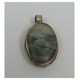 Tibetan Silver Oval Pendant with Stone Inset and Relief Carving
