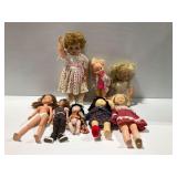 Group of Dolls with Various Outfits and Materials