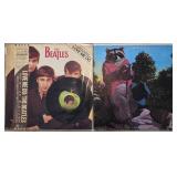 Two Vinyl Records With Album Covers