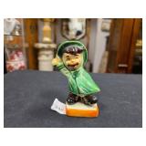 Vintage 'googly - eyed' porcelain boy in raincoat