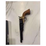 Non-firing replica of a Colt Army Model 1860 revolver, featuring a brass frame and wooden grip