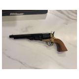 Non-firing replica of a Colt Army Model 1860 revolver, featuring a brass frame and wooden grip