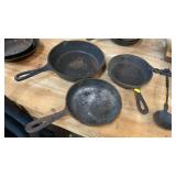 THREE CAST IRON SKILLETS