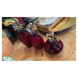 THREE RED GLASS DECANTERS