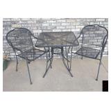 Three piece wrought iron table and chairs.
