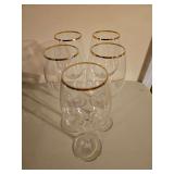 Set a five, gold rimmed, wine glasses