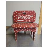 Small bench painted in Coca-Cola representative colors.