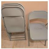 Four metal folding chairs