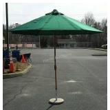 Green patio umbrella with stand, opens to be 8
