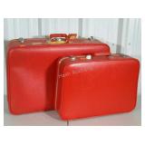 Set of red FEATHER LITE suitcases. Both with keys.