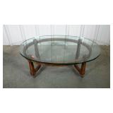 Glad topped oval coffee table on wheels. Glass