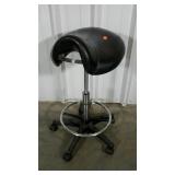 Rolling backless work stool. Saddle seat style.