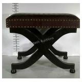 Upholstered stool with nailhead embellishments.