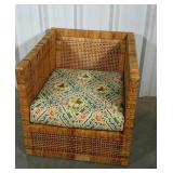 Woven natural fiber chair with cushion. Does