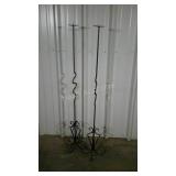Two wrought iron pillar candle stands. 57" high.