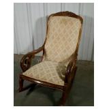 Upholstered parlor rocker. Wooden frame needs