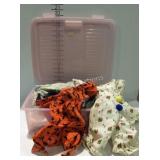 Rubbermaid container full of doll clothing