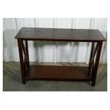 Foyer table. Dark stain, X design. Shows wear.