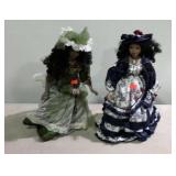 Two porcelain dolls on stands 20 inches tall