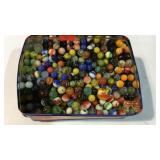Container full of marbles some shooters