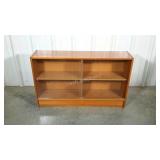 Low bookcase with sliding glass doors.